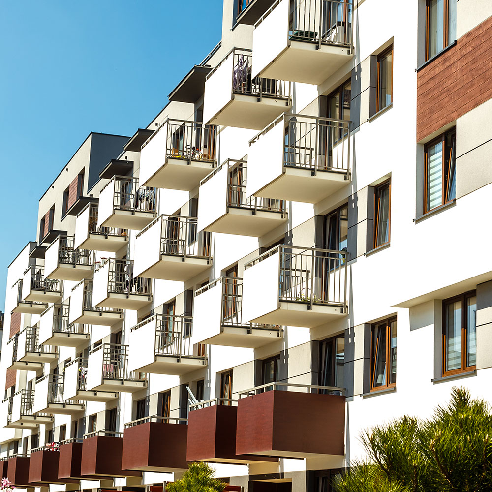 Exterior of new apartment buildings on a blue sky background.